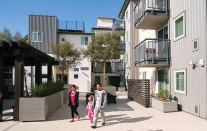 Green features at Rio Vista Apartments include reclaimed water irrigation, solar water heating, and a rooftop garden.