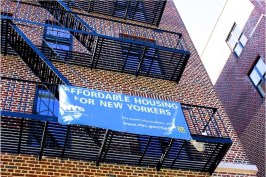 Development and finance partners celebrated the completion of the 72-unit building at 552 Academy Street in Inwood in mid-April.