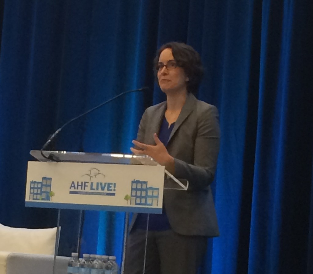 Elizabeth Kneebone, a fellow at the Metropolitan Policy Program at The Brookings Institution, addresses attendees at AHF Live: Housing Developers Forum in Arlington, Va., on May 11.
