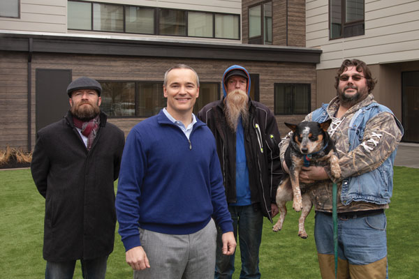 The Pacific Cos. and Northwest Integrity Housing opened the first permanent supportive housing development in Idaho last year. Pictured are Caleb Roope (front), president and CEO of The Pacific Cos., with residents of New Path Community Housing in Boise.