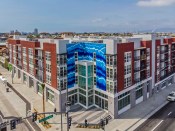 With a dramatic three-story blue tile mural echoing the waves of the nearby seaside, Las Ventanas provides needed affordable housing in Long Beach, California. The 102-unit project is the latest development completed by AMCAL Multi-Housing.