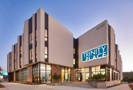 Trinity Place has three stories of studio apartments furnished to meet the needs of seniors who have been homeless. The ground floor has a grand lobby, a landscaped courtyard with seating, offices for medical and social services, and a large community room to host resident gatherings and workshops.