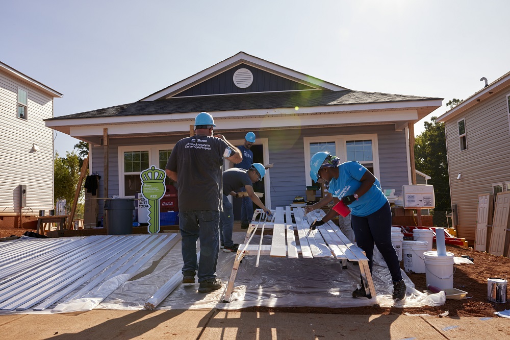 Volunteers come together to help families build their homes at Habitat for Humanity's Jimmy and Rosalynn Carter Work Project in Charlotte, North Carolina.