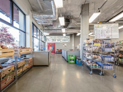After operating in a church basement for the past three decades, the University District Food Bank now has 5,900 square feet of interior space with prominent street frontage plus a 7,000-square-foot rooftop organic farm for low-income residents of the local community.