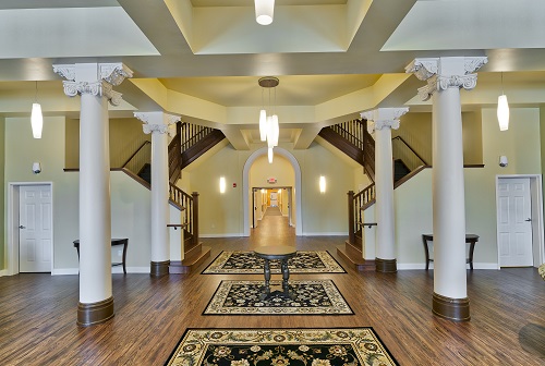 A large activity room with two stories of south-facing windows is choreographed to flow into the corridors and stairs in the central core.