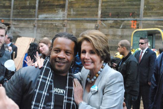 U.S. Rep. Nancy Pelosi with Tyrone Hopper, who has been assisted by the St. Anthony Foundation.