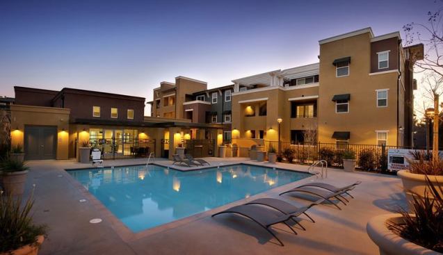 The multigenerational property encompasses three distinctively styled buildings–a separate building for senior citizens and two buildings for families–as well as a shared community center and a pool area.