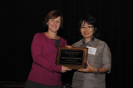 The winner of the preservation category is Kukui Gardens Apartments in Honolulu, developed by EAH Housing and Devine & Gong. Marian Gushiken (right), EAH’s director of real estate development in Hawaii, accepts the award from Affordable Housing Finance Executive Editor Christine Serlin.