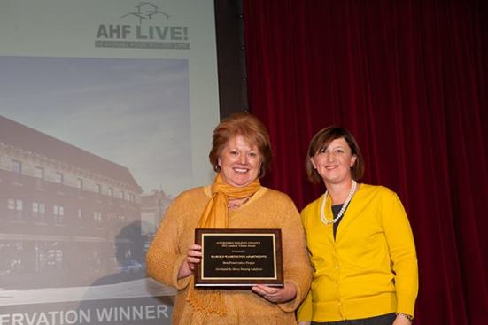The winner of the preservation category is Harold Washington Apartments in Chicago, developed by Mercy Housing Lakefront. Cindy Holler (left), president of Mercy Housing Lakefront, accepts the award from Affordable Housing Finance Executive Editor Christine Serlin.