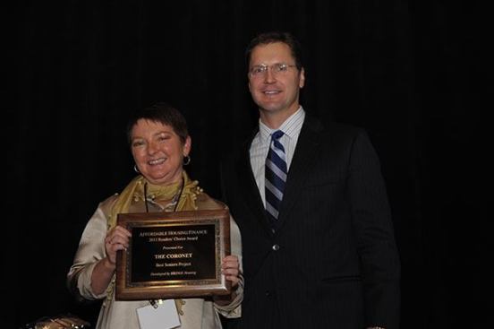 The winner of the seniors category is The Coronet in San Francisco, developed by BRIDGE Housing. Cynthia Parker, president and CEO of BRIDGE Housing, accepts the award from David Leopold, senior vice president of Bank of America Merrill Lynch.
