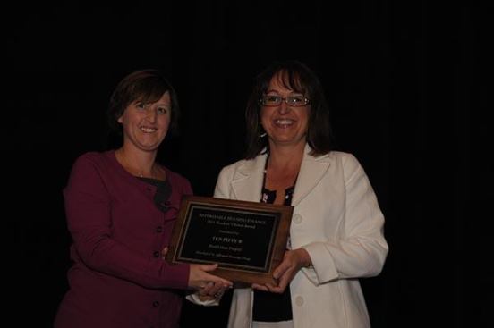 The honor for top urban development goes to Ten Fifty B in San Diego, developed by Affirmed Housing Group. Nicki Cometa (right), CFO of Affirmed Housing Group, accepts the award from Affordable Housing Finance Executive Editor Christine Serlin.