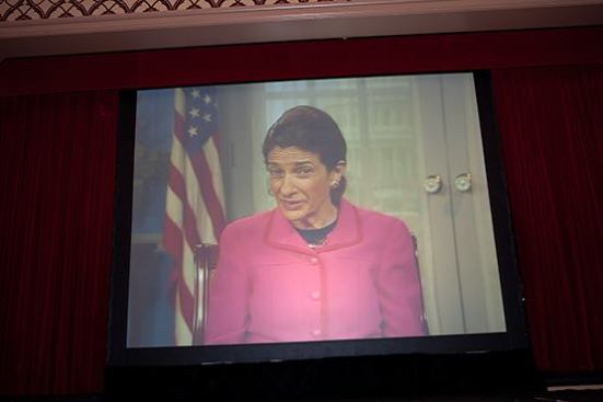 Sen. Olympia Snowe addresses the luncheon audience via video.
