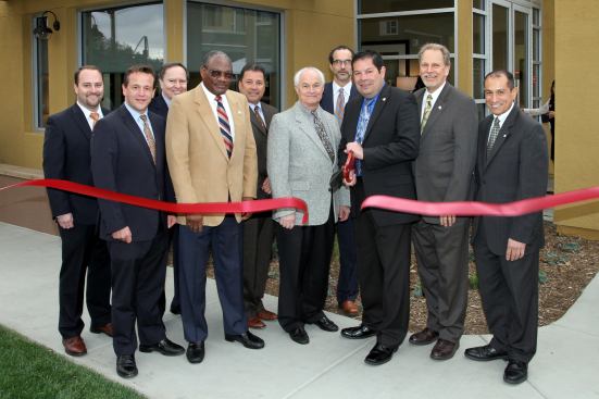 Mayor Larry Schroeder, second from the right, with Claremont city officials and Jamboree executives at the ribbon cutting for the grand opening of Courier Place.