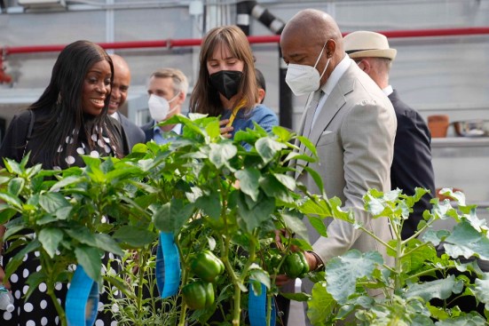 Eva Joly, horticultural therapist at Project Renewal's Bedford Green House (center), shows the development's garden to New York City Mayor Eric Adams and Vanessa Gibson, Bronx borough president.