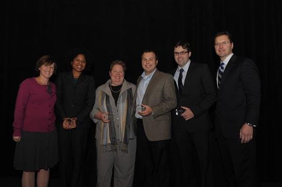 Affordable Housing Finance Executive Editor Christine Serlin (left) and Bank of America Merrill Lynch Senior Vice President David Leopold (right) also honored the magazine’s fourth annual Young Leader recipients. The 2011 Young Leaders are Karyntha Cadogan, development officer at The Michaels Development Co.; Andrea Papanastassiou, director of real estate development at Eden Housing, Inc.; Jimmy Royster, development associate at The Affordable Housing Group of North Carolina; and Ken Naylor, COO at Carlisle Development Group.