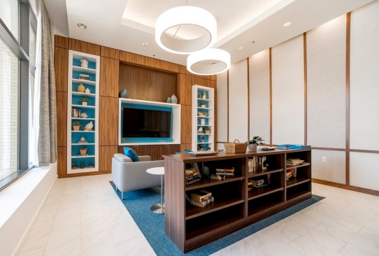 The $44 million project features 149 apartments plus a large community room, a cyber cafe with computers, and a fitness center.