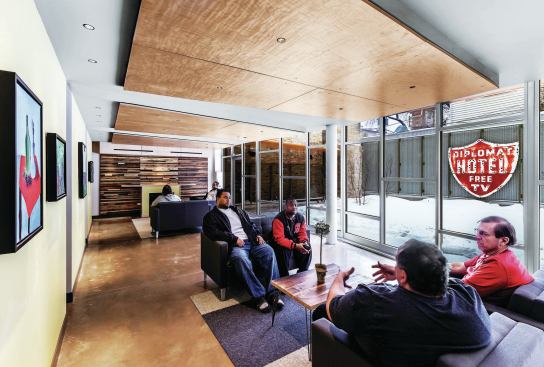 Amenities include a fitness center, a computer lab, community spaces, a conference room, a landscaped courtyard, a reception desk, management offices, a warming kitchen, and storage spaces.