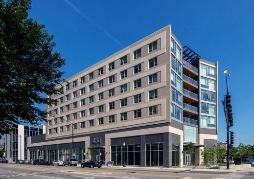 Designed by Pappageorge Haymes Partners, Clybourn 1200 has a "book-shaped" design. The seven-story concrete building maintains the acute angle of the site while glazed end walls, anchored by a glass feature and a canopy at the "spine," provide a backdrop to the corner plaza. Window units are punctuated with a bright contrasting color.