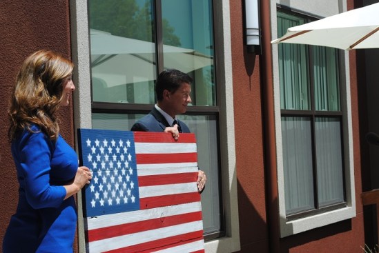 David Haubert, mayor of Dublin, Calif., presents artwork of the U.S. flag to Valor Crossing at the development's July 20, 2017, grand opening ceremony.