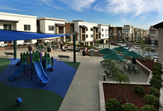 The development is family-focused, featuring a tot lot, outdoor dining and barbecue areas, and fitness, computer, media, and activity rooms.