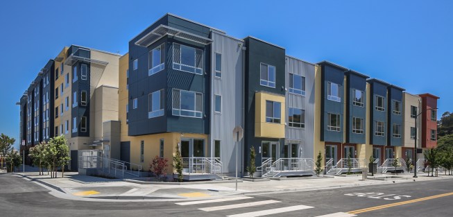The flat-style and townhouse apartments wrap around center courtyards to provide private outdoor space and are built over at-grade parking structures. All phases have a certification goal of LEED Gold.
