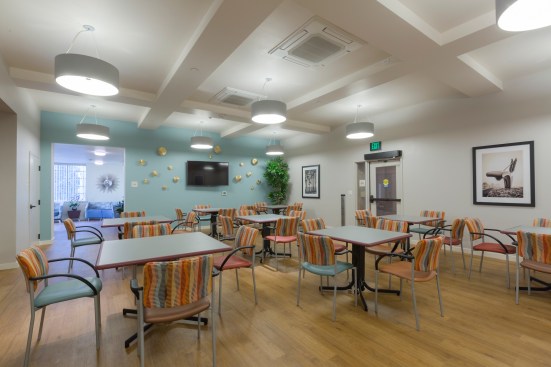 Besides social services, amenities include cameras with closed-circuit video surveillance, a large community room with a kitchen, a coffee lounge room, a landscaped courtyard on the second floor, and a terrace adjacent to the coffee lounge room.