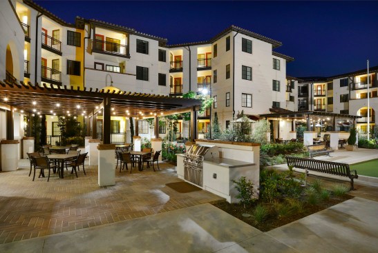 The Spanish Mediterranean-style community, designed by KTGY Architecture + Planning with MJS Landscape Architecture, features a wealth of outdoor amenities, including a bocce ball court, a dining terrace, and a dog park.