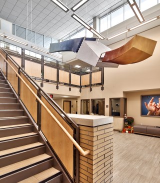 Line of sight is a critical consideration throughout the project. The reception desk, the community room, and the lobby are all connected spatially or with windows. Computer lounges are oriented so users face obliquely to the open walkway, rather than having their backs turned. Wide corridors allow two residents to walk while signing and leave room for a third resident to pass.