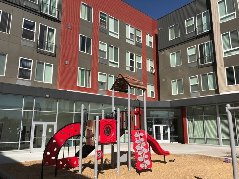 The development has a community room for resident and community functions, a computer lab, a children's play room, and a courtyard with play equipment and sitting areas for adults.