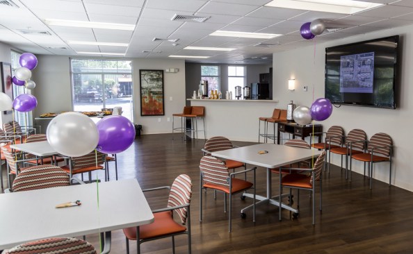 The project also includes a large community room with a kitchenette, an audio-visual recording studio, a dog walk area, a tot lot, a community garden, and two furnished patios.