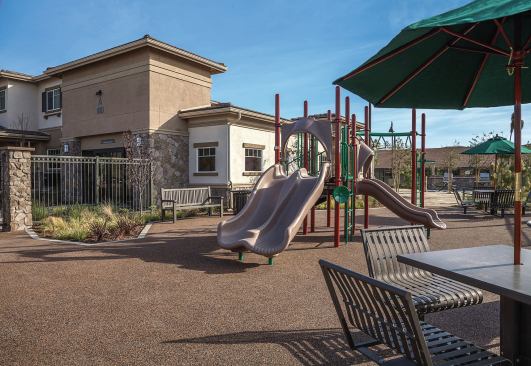 A tot lot with open space provides children with a place to play and learn social skills.