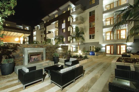 The project offers ample outdoor space for the residents, including community gardens, a dog park, a spa, and barbecue areas.