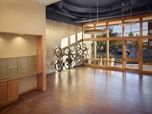 "The building’s lobby utilizes people-powered urban transit as sculpture," according to Capitol Hill Housing. A line of wall-mounted bike racks greets residents and visitors immediately upon entry.