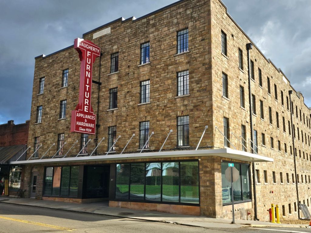 Daugherty Lofts preserves the architectural character of the original building, with features such as original milk doors, a 20th century stone exterior, metal casement windows, rustic hardwood floors, and a restored fifth floor skylight.